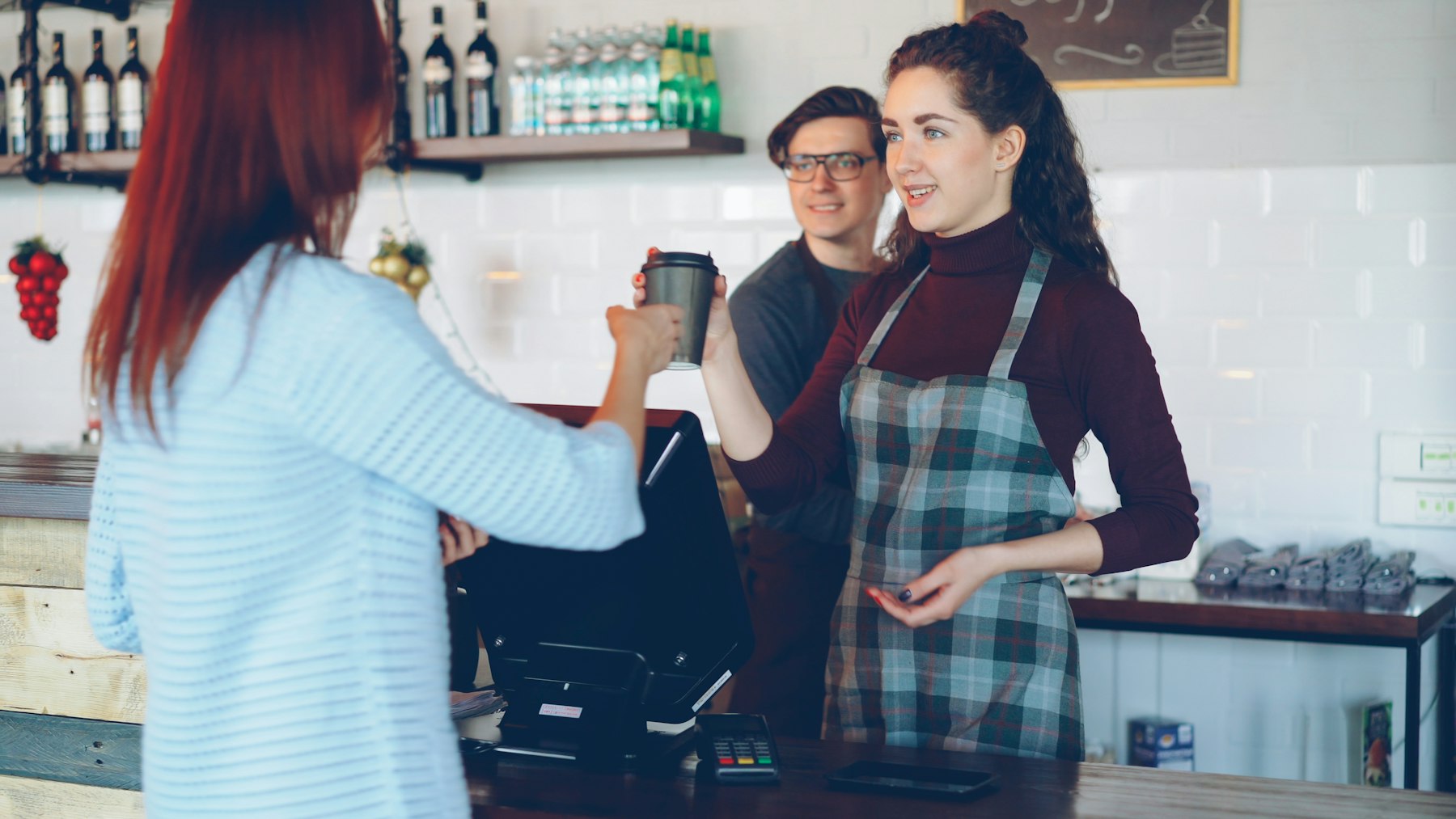 Customer paying at a café counter